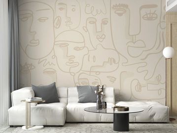 Modern living room with abstract face mural and minimalist furniture.