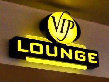 Bright yellow VIP Lounge sign on a wall.