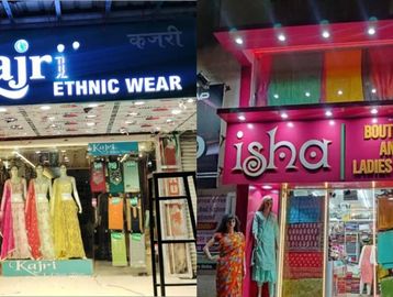 Two ethnic wear stores with mannequins displaying traditional attire at night.