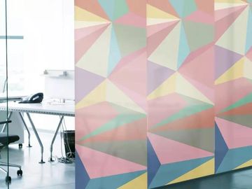 Colorful geometric patterned office partition in a modern workspace.