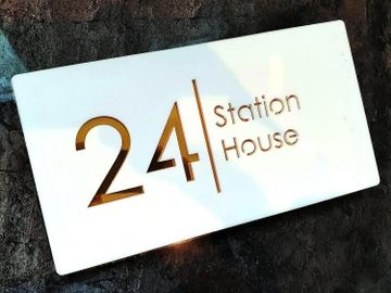 A sign reading '24 Station House' on a white rectangular plaque.