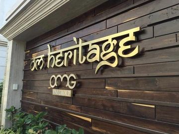 Signboard displaying 'Om Heritage' on a wooden background.