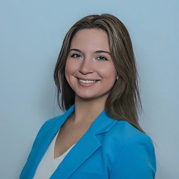 Professional portrait of a smiling woman in a blue blazer.