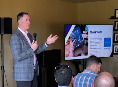 Man giving presentation with a microphone.