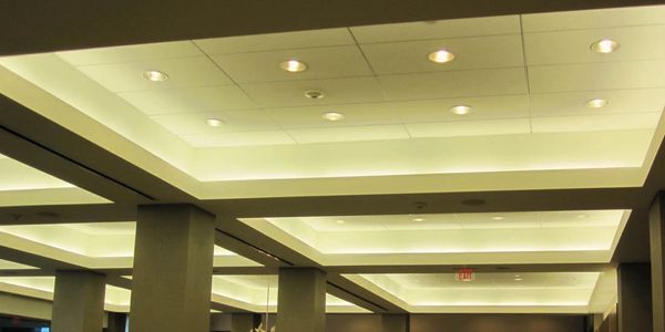 Ceiling with recessed lighting in an office or hall.