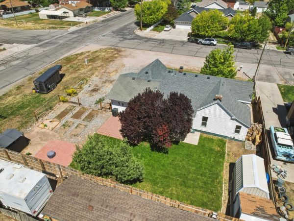 Aerial view of a house with a garden and backyard.