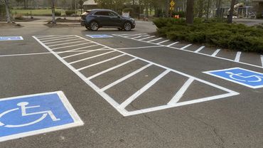 Parking lot striping with ADA stencils