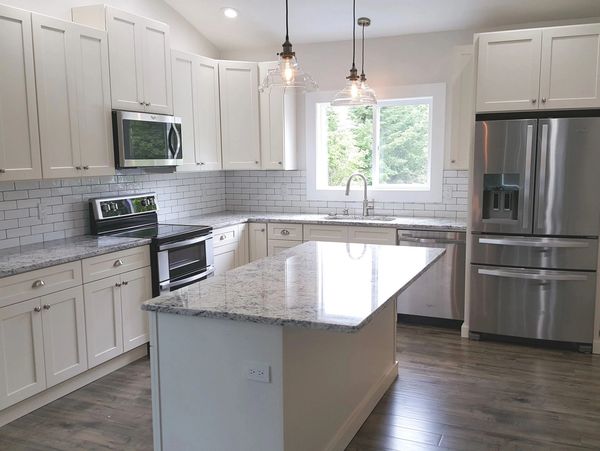 Kitchen Remodel including new lighting, slab granite countertops and custom cabinets.
