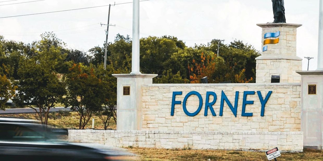Sign of Forney on a brick wall, located off of US 80 (sourced from https://www.dallasnews.com)