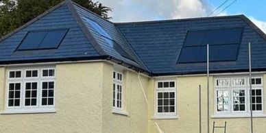 Re-roof in Beccles using natural slates with hips and valleys and solar panels on the roof.