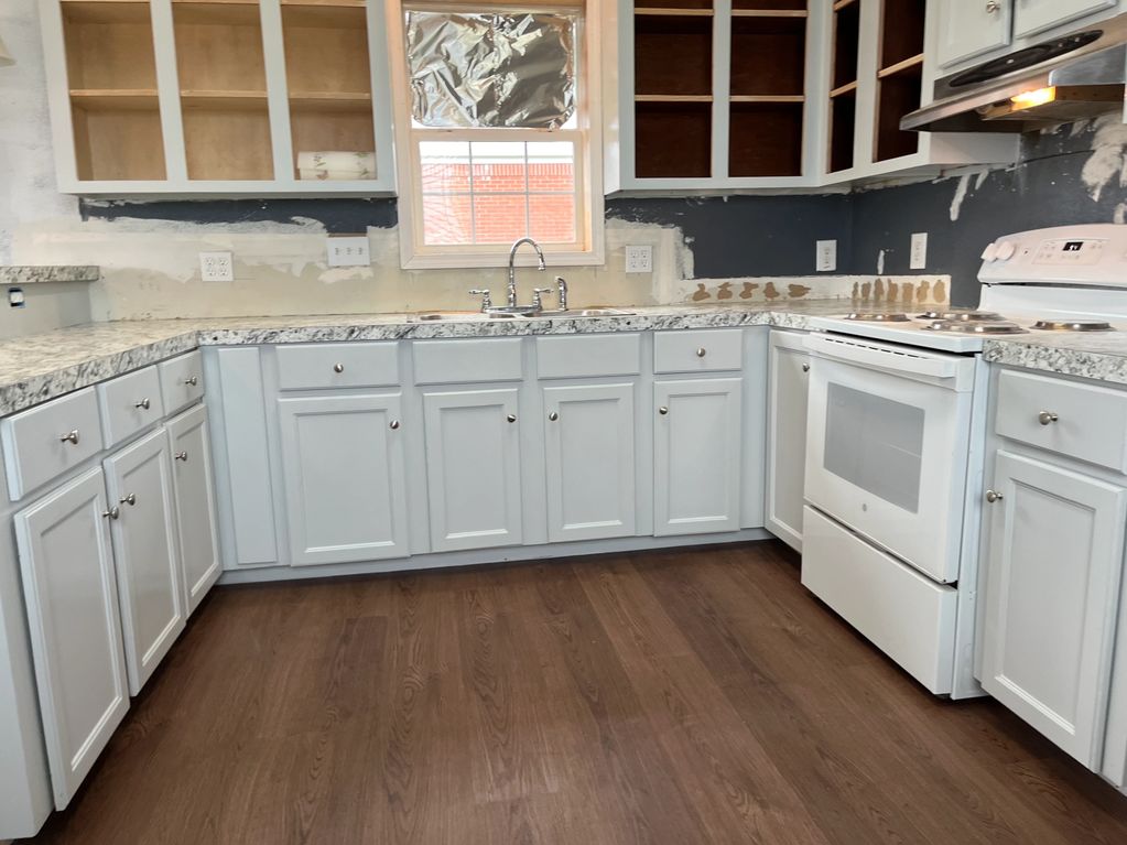 After professional kitchen cabinet painting and flooring in Chauvin LA.