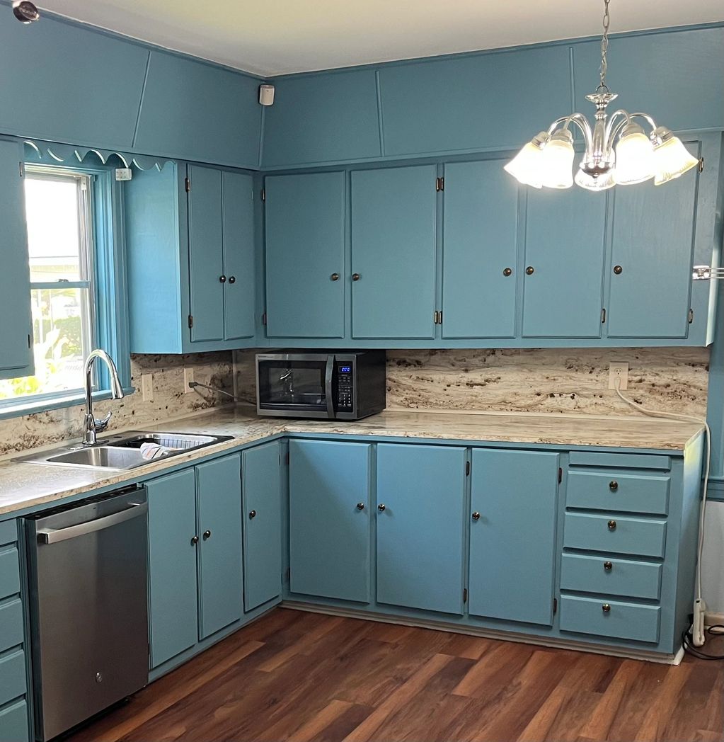 Kitchen cabinet painting in Houma LA. We stained cabinets, replaced countertops, and backsplash.