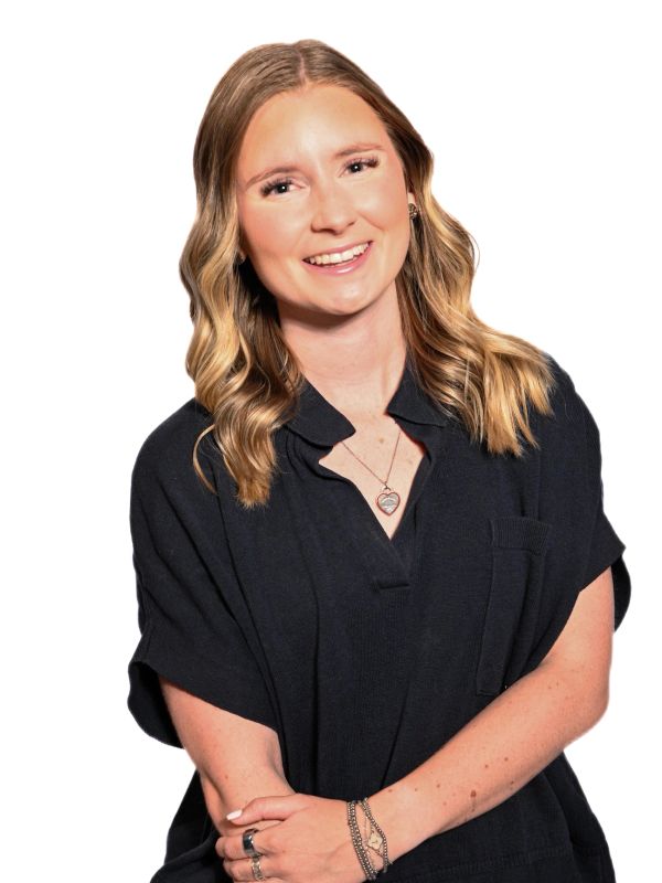 Smiling woman with wavy hair in black shirt.