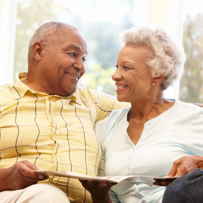 A senior African American couple looking at each other representing reverse mortgages, mortgage.