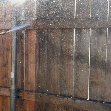 Yellow industrial floor sweeper machine parked outdoors.