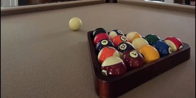 Billiard balls racked on a pool table.