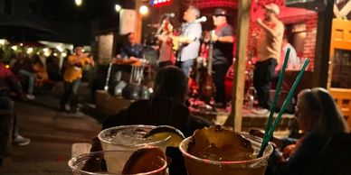 Drinks and live music at an outdoor venue.