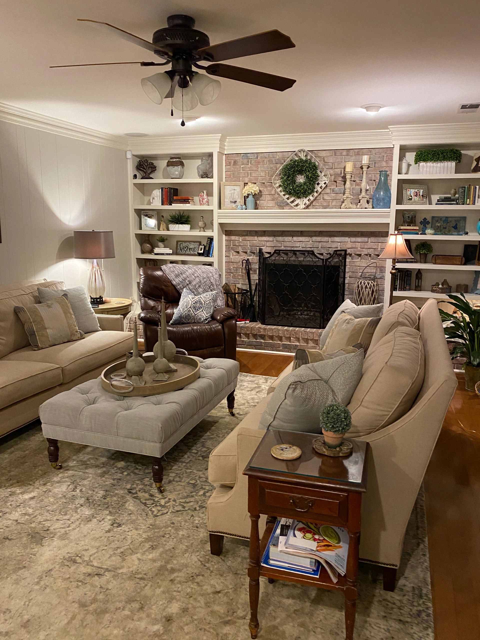 After- Having 2 sofas created focal point in fireplace that was styled to reflect client taste