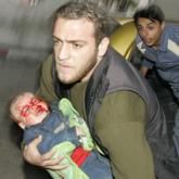 A Palestinian boy wounded during Israel’s offensive is carried into Shifa hospital in Gaza. Israeli forces edged into the Gaza Strip’s most populous area on Sunday, killing at least 27 Palestinians in an offensive stepped up in defiance of international calls for a ceasefire