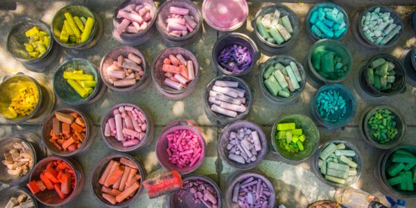 Buckets of chalk sorted by color