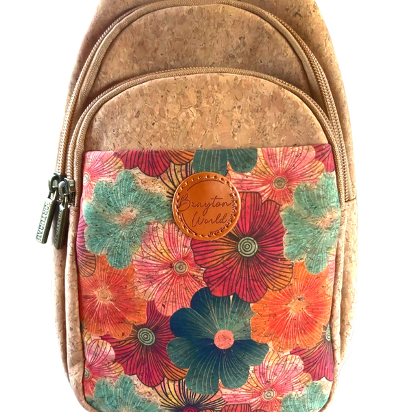 Small backpack with cork material and colorful floral front pocket.