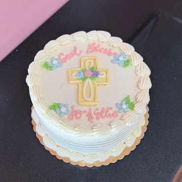 Round communion cake with pink writing and butter cream frosting