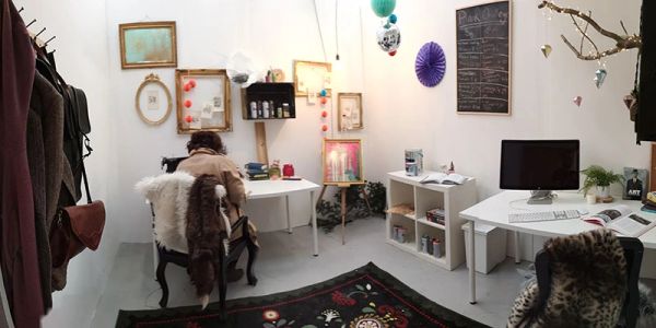 Cozy art studio with two workstations and creative decor.