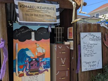 A community pirate pantry with pirate-themed signs and decorations.