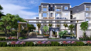 Modern residential complex entrance with landscaping and clear signage.