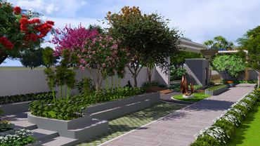 Modern garden with colorful flowering trees and a sculpture along a paved pathway.