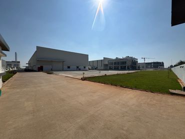 Industrial complex with large buildings and clear blue sky.