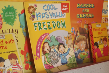 Colorful children's books displayed on a shelf.