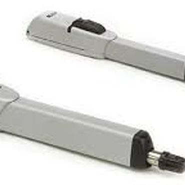 Two gray telescoping tools with black adjustment knobs.