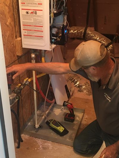 plumber checking water pressure in water heater