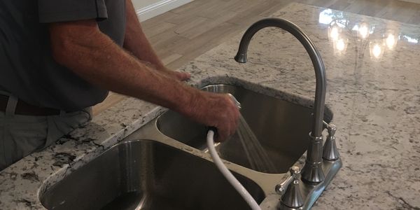 plumber checking if water spray works