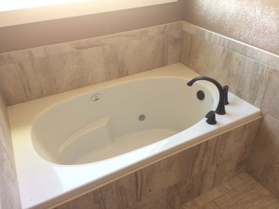 new soaker tub with black faucet