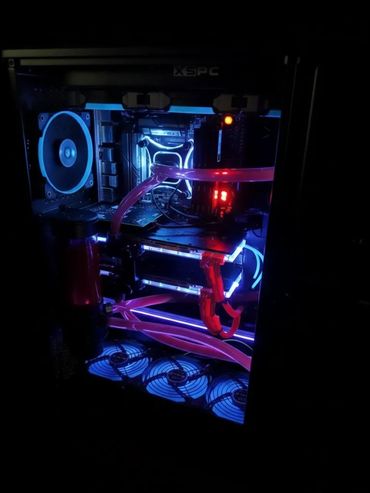 High-performance PC with custom liquid cooling and vibrant UV lighting.