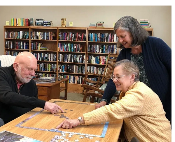 Group of people completing a puzzle