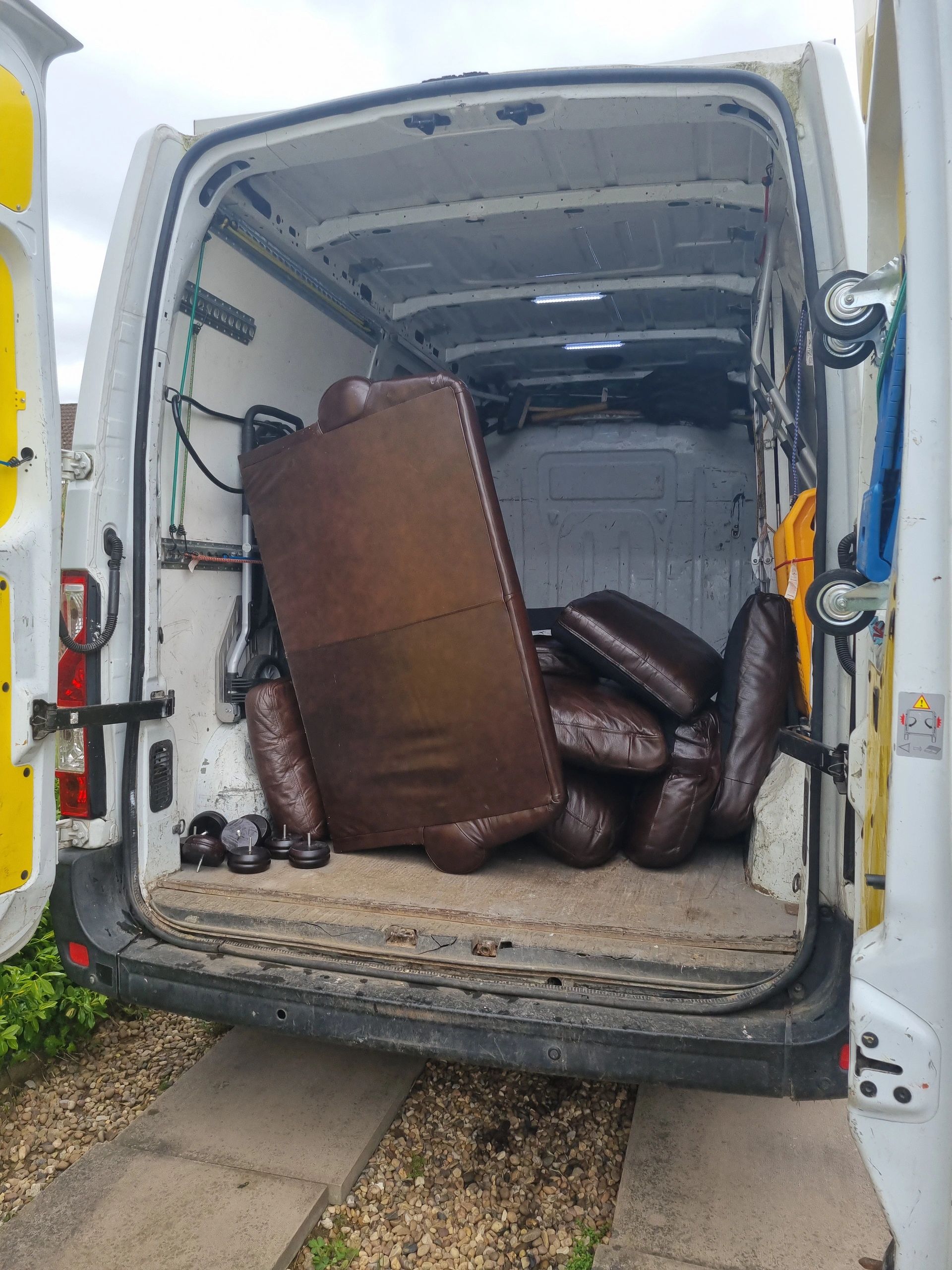 Brown Sofa in van ready for disposal