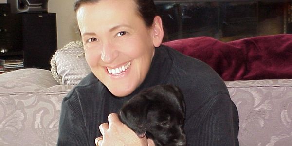 Dale Ward holding black puppy.