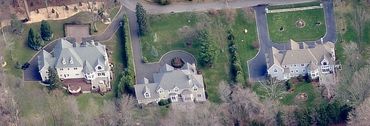 Aerial view of a large house and property.