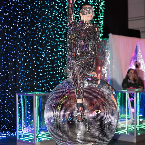 Giant rotating disco ball contortion, disco ball hand balancing, mirror performer.