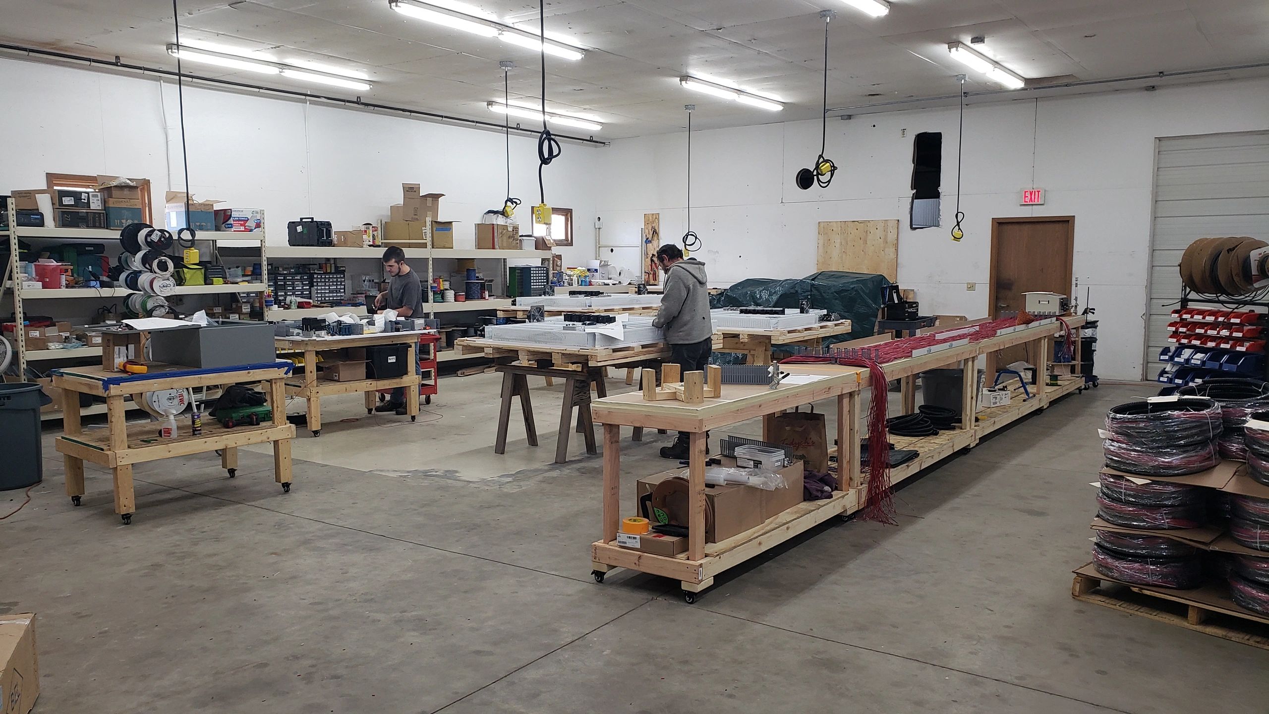 Panel shop showing wiring harnesses and industrial control panels.