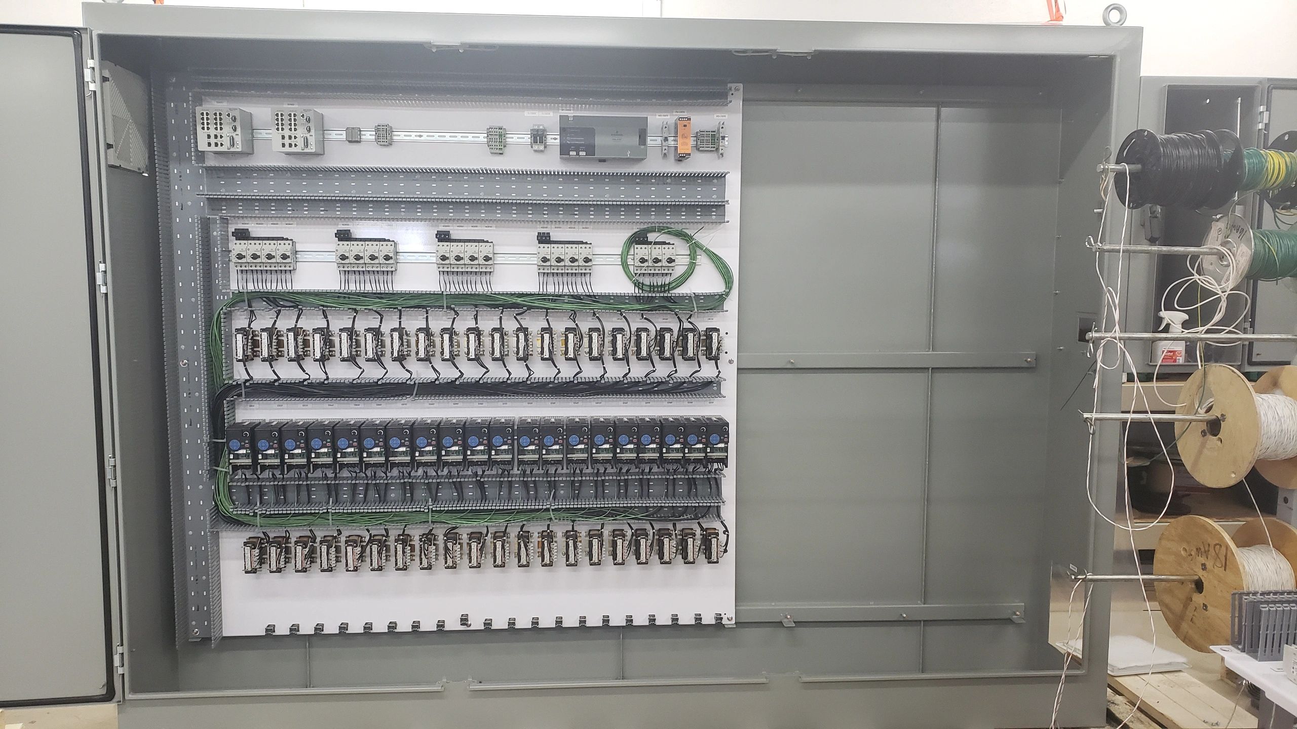 Industrial control panel construction showing VFD's (variable frequency drives) installed and wired.