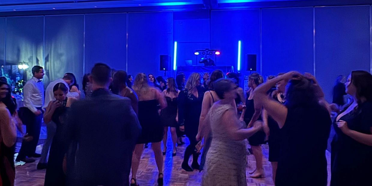 Guests dancing at a formal event in Kamloops with full lighting and DJ setup.