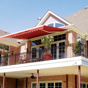 Red Retractable Awning with White Trim on Second Story Patio