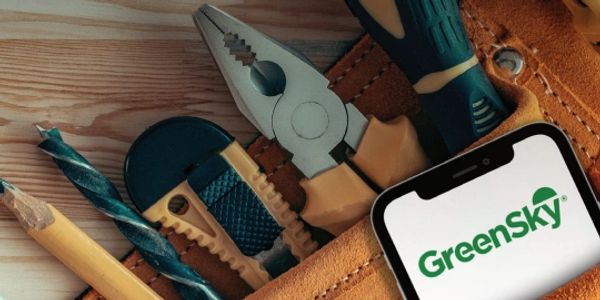 Tool belt with pencil, pliers, and phone with GreenSky label