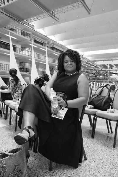 Professor Bridget Fizer sitting in chair @ FGI Dallas Show & Competition