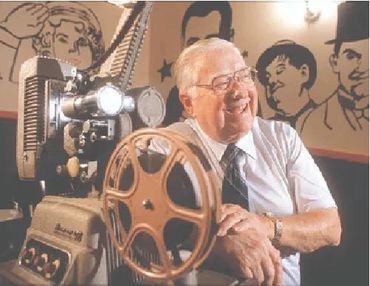 Earl Jernigan at a film projector.