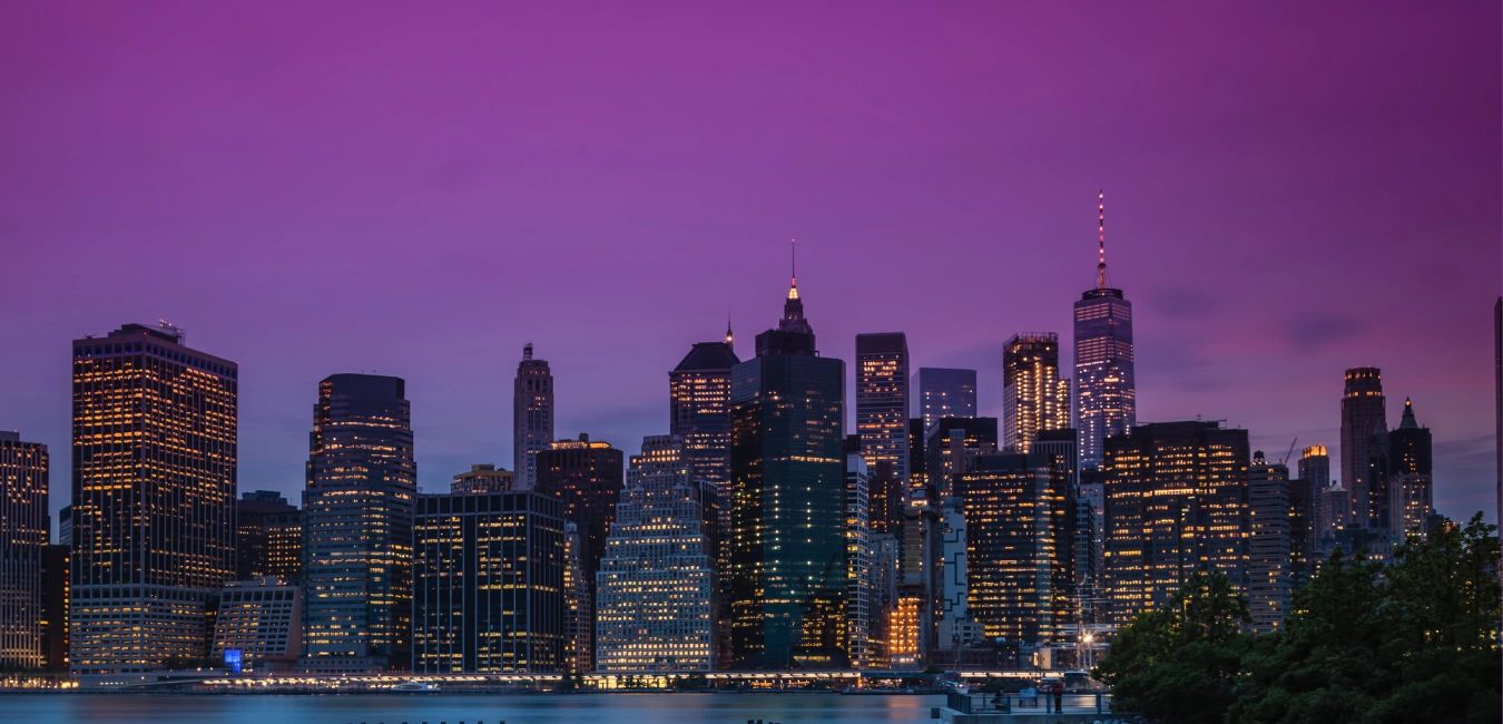 City skyline at dusk with purple sky.
